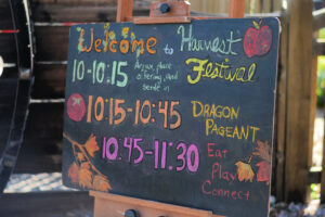 Harvest Festival schedule on a chalkboard